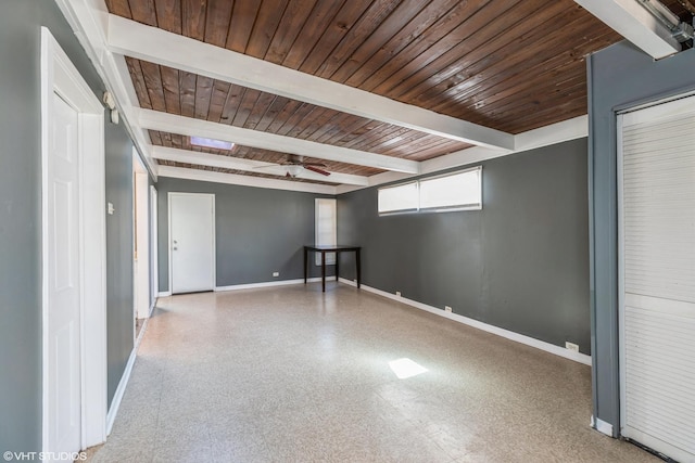 spare room featuring baseboards, ceiling fan, wood ceiling, tile patterned floors, and beamed ceiling