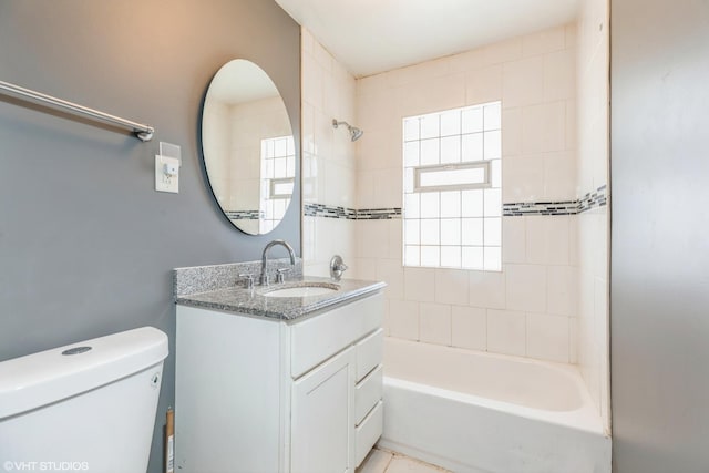 bathroom featuring toilet, shower / washtub combination, and vanity