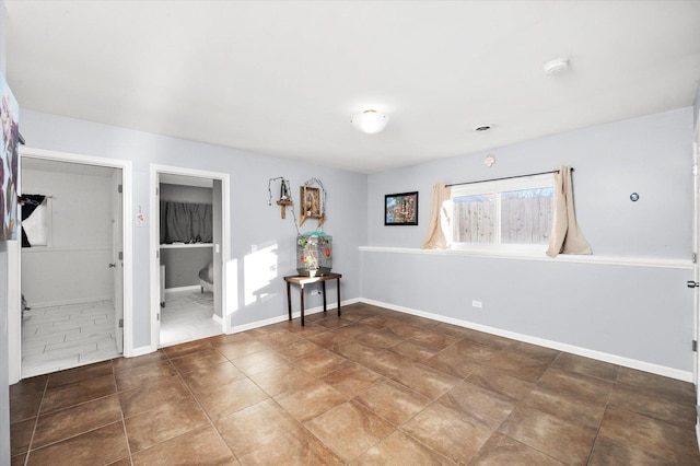 empty room featuring baseboards