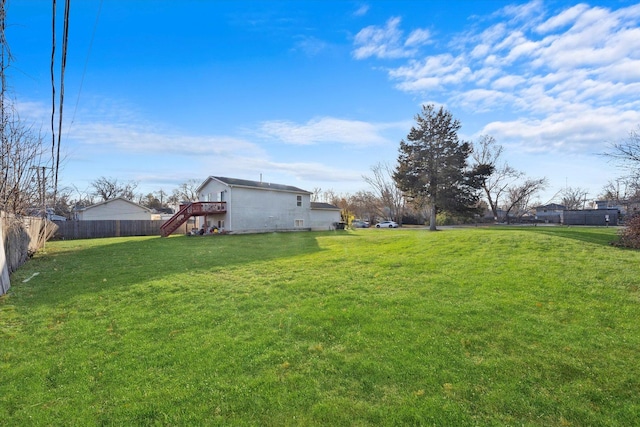 view of yard with stairs and fence