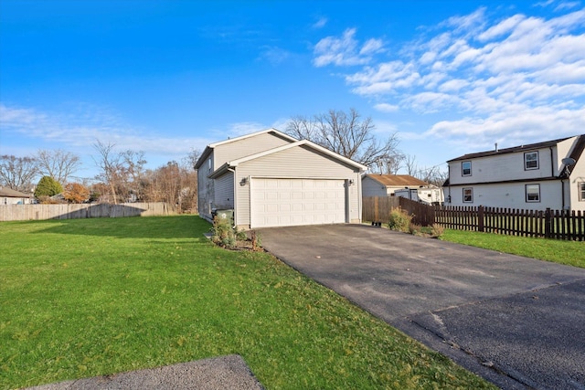 view of property exterior featuring fence, a garage, a residential view, and a lawn