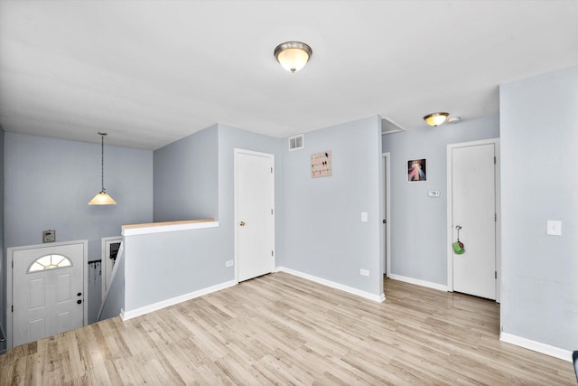 entrance foyer with visible vents, baseboards, and wood finished floors