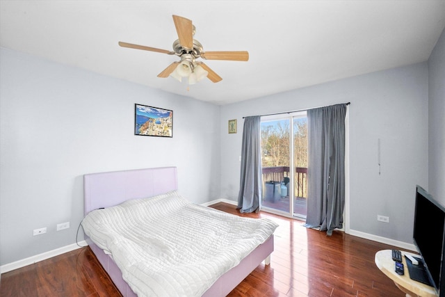 bedroom featuring access to exterior, baseboards, and wood finished floors