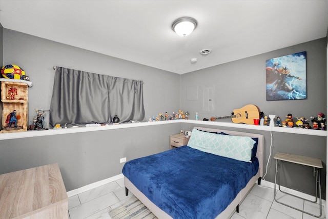 bedroom featuring baseboards and marble finish floor