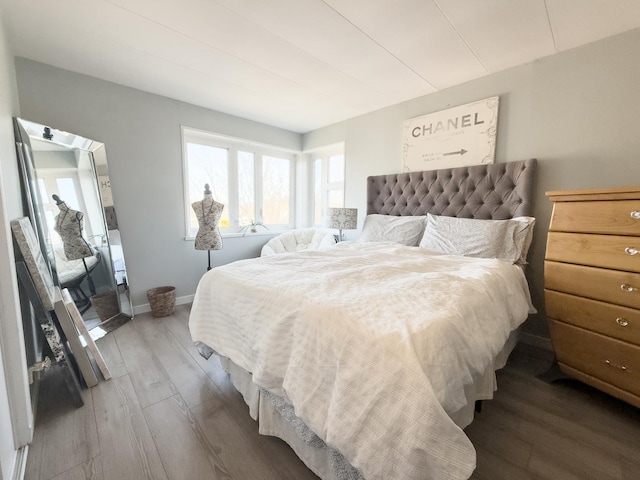 bedroom with wood finished floors and baseboards