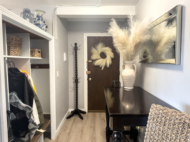 interior space featuring baseboards and wood finished floors