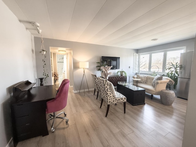 living room featuring wood finished floors and baseboards