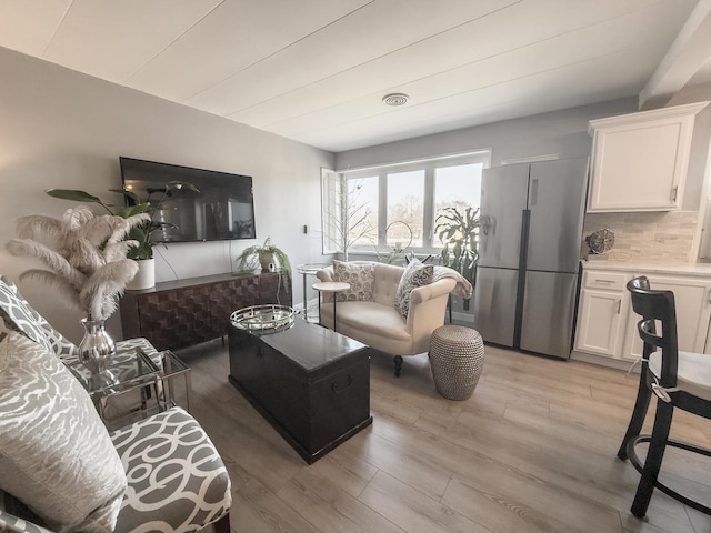 living room featuring light wood finished floors and visible vents