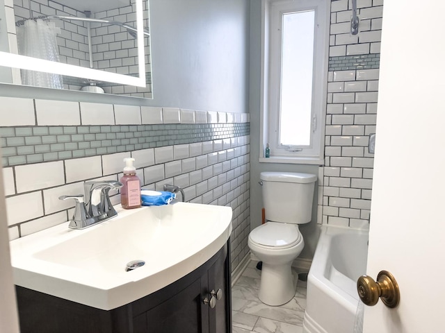 full bath featuring toilet, a tub to relax in, marble finish floor, a shower with shower curtain, and vanity