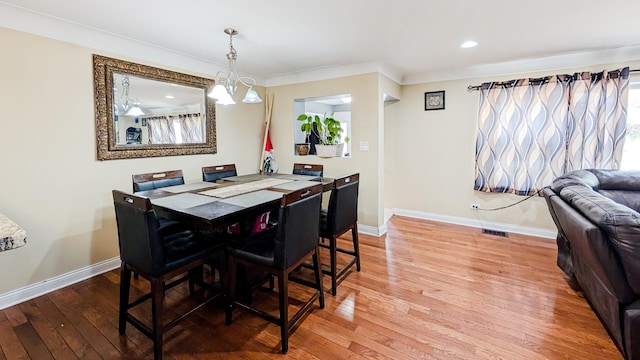 dining area with visible vents, baseboards, and light wood-style floors