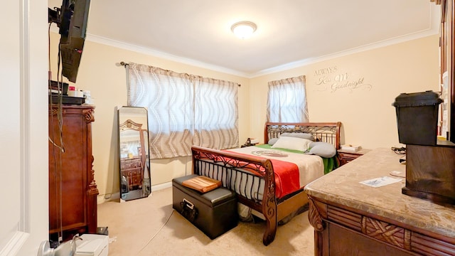 bedroom featuring light colored carpet, baseboards, and ornamental molding