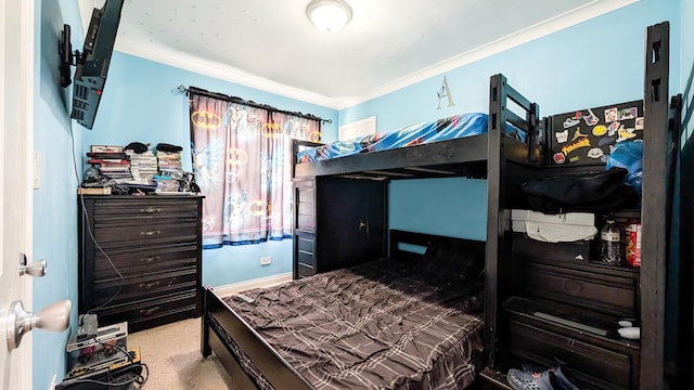 carpeted bedroom featuring baseboards and crown molding