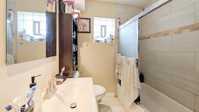 full bath with a sink, enclosed tub / shower combo, toilet, and tile patterned flooring