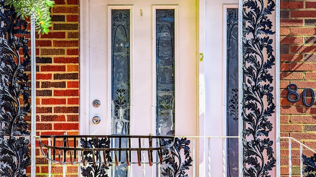 property entrance featuring brick siding