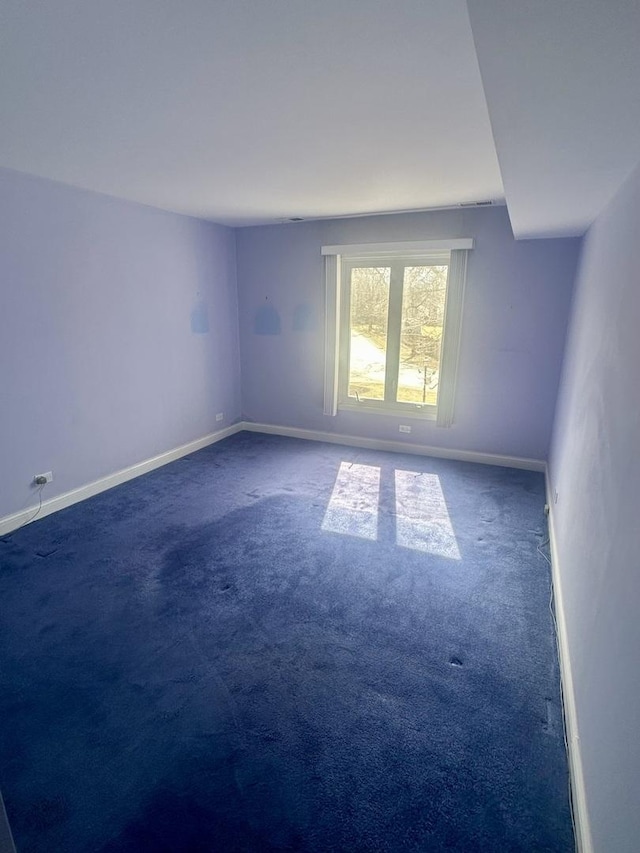 carpeted spare room with baseboards