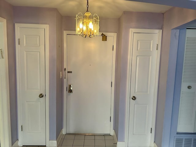 interior space featuring light tile patterned floors, a notable chandelier, baseboards, and visible vents