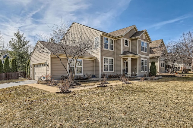 view of front of house featuring an attached garage, driveway, a front lawn, and fence