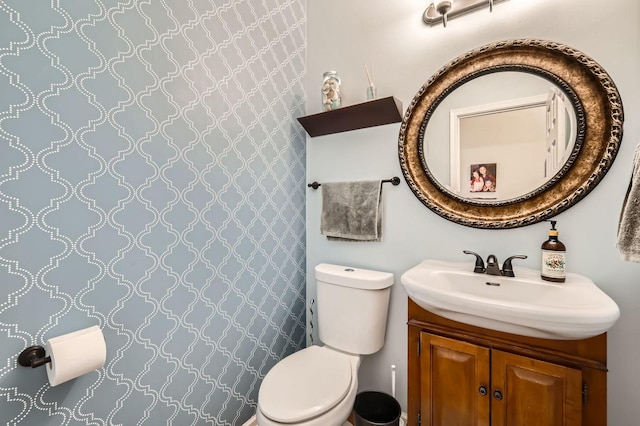 bathroom featuring toilet and vanity