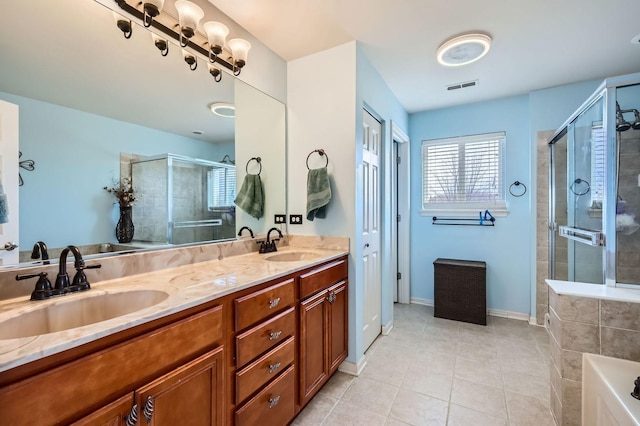 bathroom with a stall shower, visible vents, and a sink