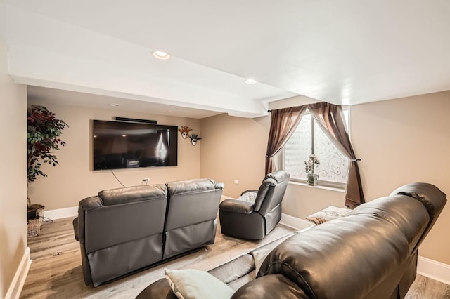 home theater room featuring recessed lighting, wood finished floors, and baseboards