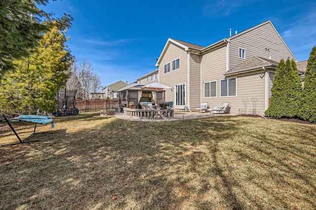 rear view of house with a yard, a patio area, and fence