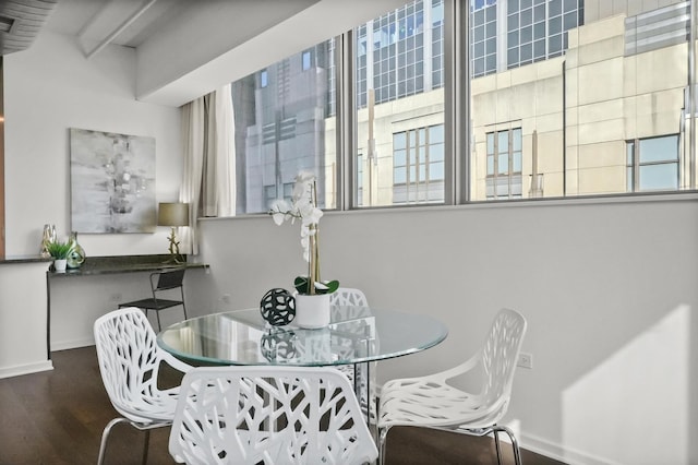 dining space featuring baseboards and wood finished floors