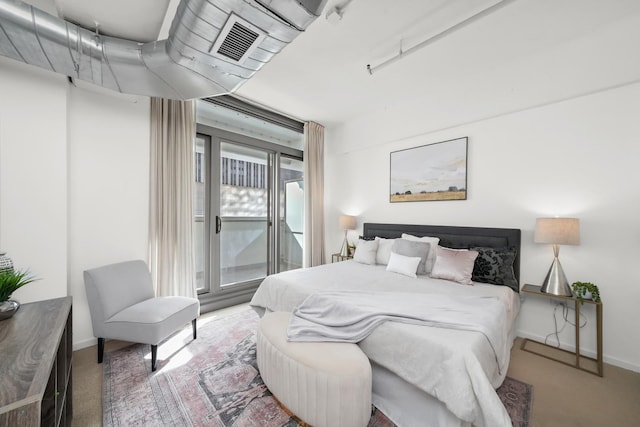 carpeted bedroom with access to exterior, visible vents, and baseboards