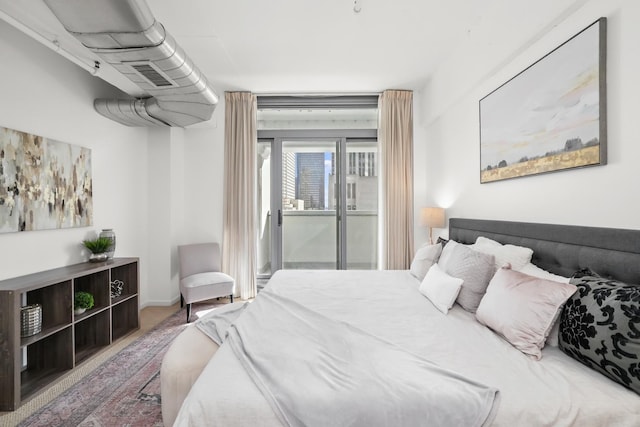 carpeted bedroom with visible vents and access to outside