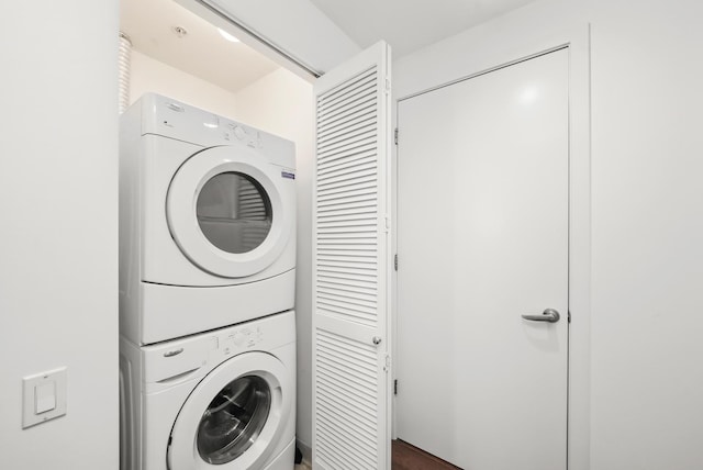 clothes washing area with laundry area and stacked washer / dryer