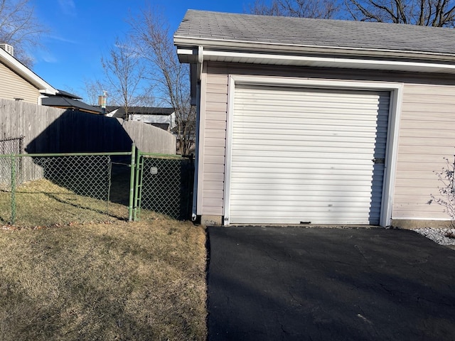 garage with a gate and fence