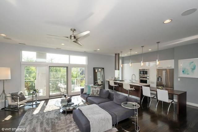 living room featuring dark wood finished floors, recessed lighting, and a healthy amount of sunlight