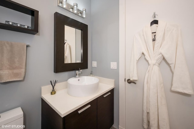 bathroom featuring toilet and vanity