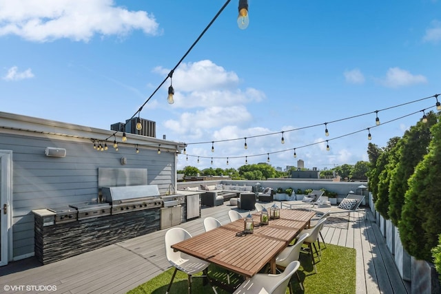 wooden terrace with area for grilling, outdoor dining space, outdoor lounge area, and exterior kitchen