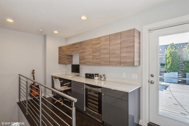 kitchen featuring wine cooler, recessed lighting, modern cabinets, and light countertops