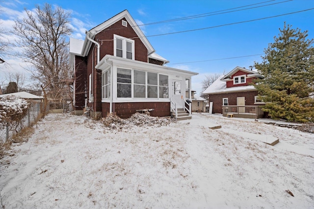 view of front of property with a sunroom