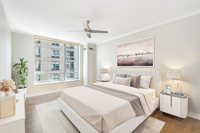 bedroom with dark wood-style floors, ceiling fan, baseboards, and ornamental molding