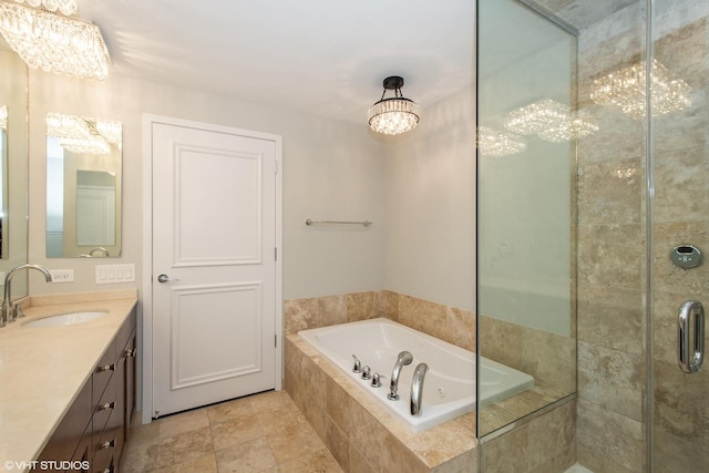 full bath with vanity, an inviting chandelier, a bath, and a tile shower