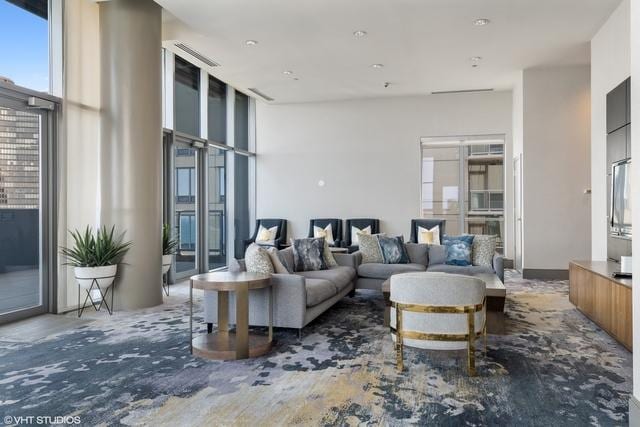 living room featuring plenty of natural light and a wall of windows