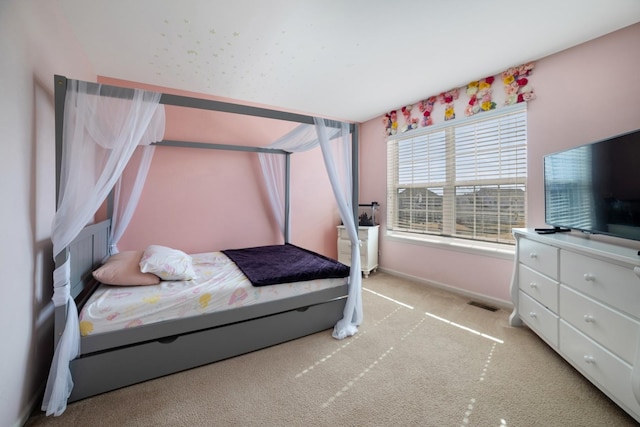 bedroom featuring visible vents, light colored carpet, and baseboards