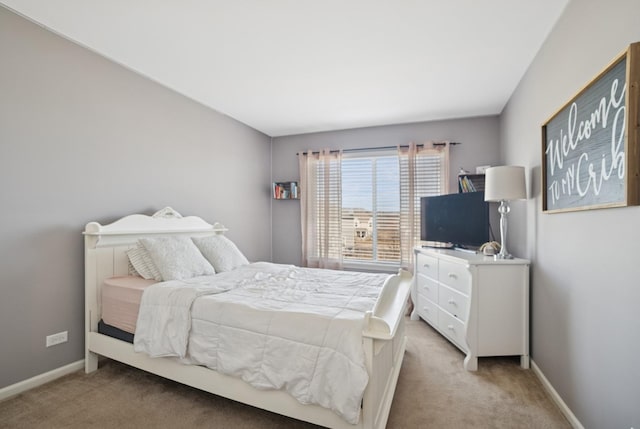 bedroom featuring light colored carpet and baseboards