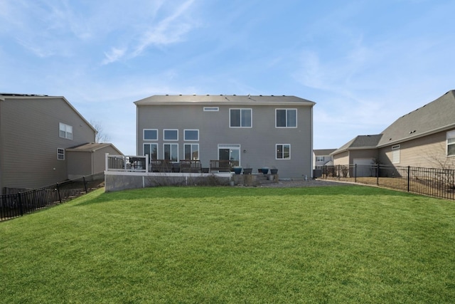 back of house featuring a fenced backyard and a yard