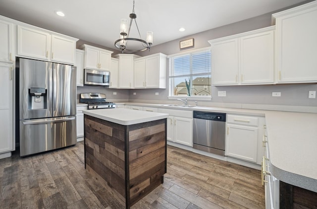 kitchen featuring a sink, appliances with stainless steel finishes, dark wood-style floors, and white cabinets