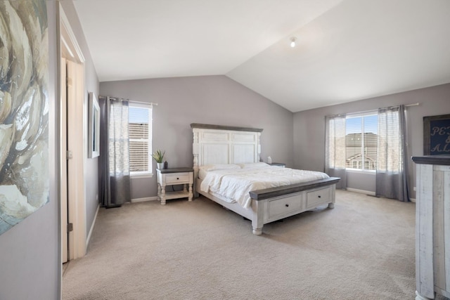 bedroom with light carpet, baseboards, and lofted ceiling