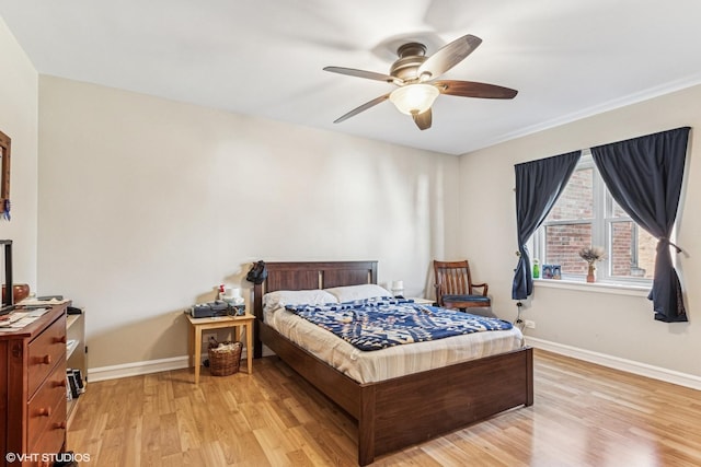 bedroom with baseboards, light wood finished floors, and ceiling fan