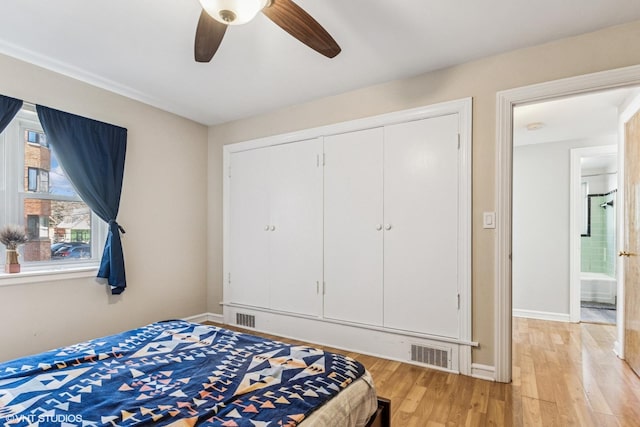 bedroom featuring light wood-type flooring, visible vents, and baseboards