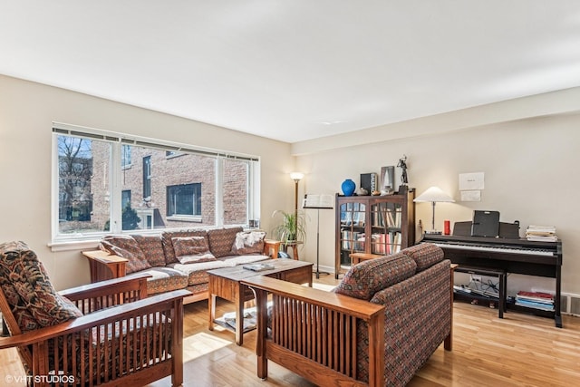 living room with light wood finished floors and baseboards