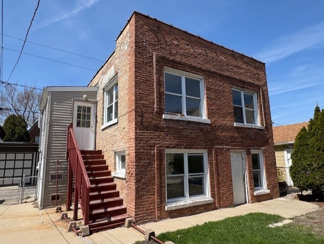 back of house featuring entry steps and brick siding
