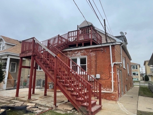 view of playground featuring stairs, a patio, and fence