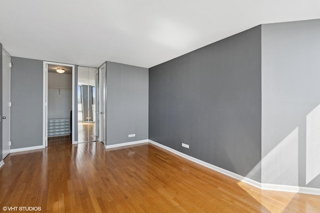 345 W Fullerton Pkwy Unit 1006, Chicago, IL 60614 - unfurnished bedroom with a closet, a spacious closet, baseboards, and wood finished floors