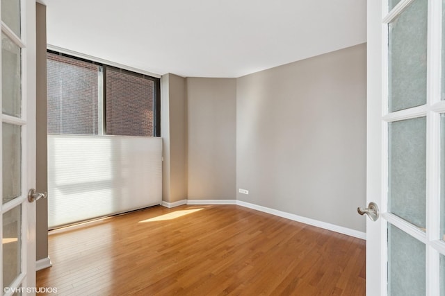 345 W Fullerton Pkwy Unit 1006, Chicago, IL 60614 - spare room with french doors, baseboards, and wood finished floors